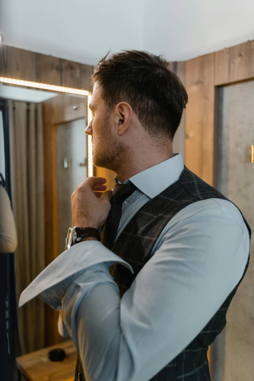 a man adjusting his tie in front of a mirror, inspired by Jesper Knudsen, pexels contest winner, wearing a vest top, wearing a plug suit, profile image, seasonal