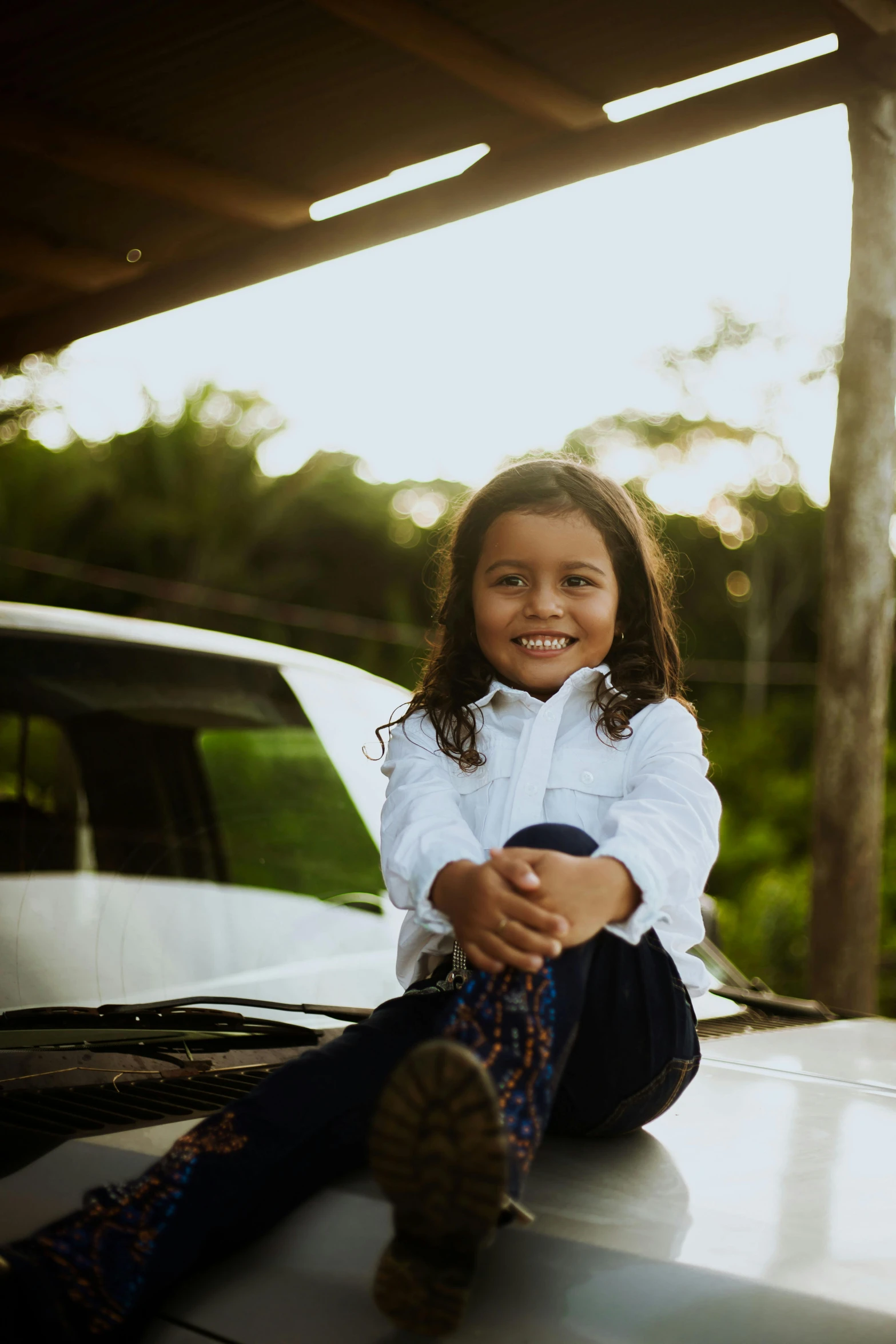 a little girl sitting on the hood of a car, pexels contest winner, wearing a white button up shirt, alanis guillen, asher duran, avatar image