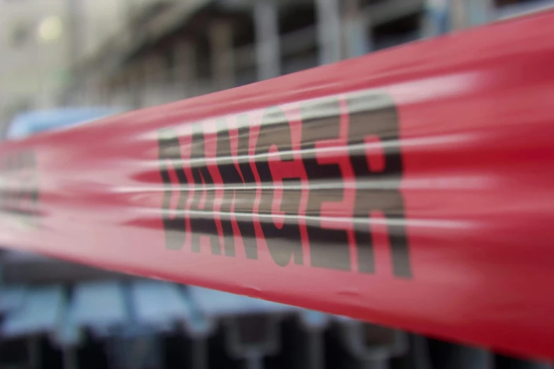 a blurry picture of a red fire hydrant, by Daniel Lieske, pexels contest winner, graffiti, holding a red banner, ranger, 3 d close - up, police tape