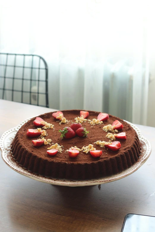 a chocolate cake sitting on top of a wooden table, 王琛, strawberry, flan, premium quality