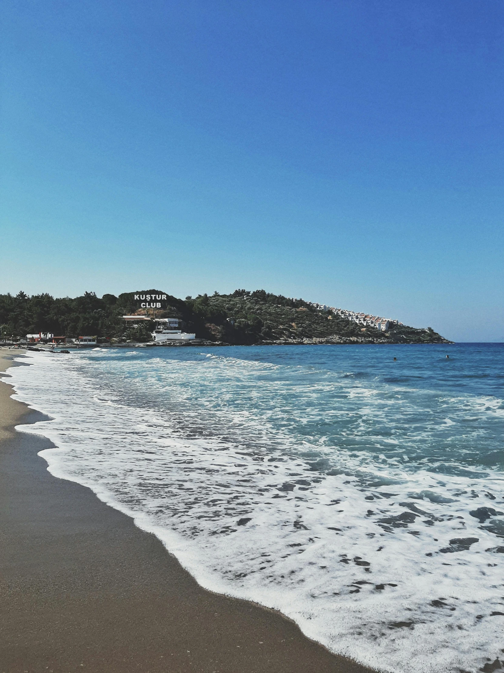 a large body of water sitting on top of a sandy beach, greek nose, walking down, next to the sea