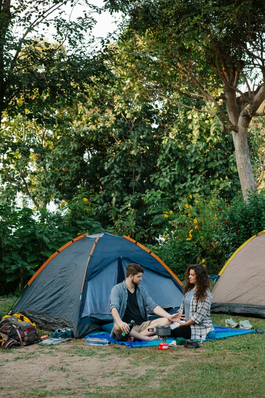 a couple of people that are sitting in the grass, tents, tawa trees, sydney, exterior