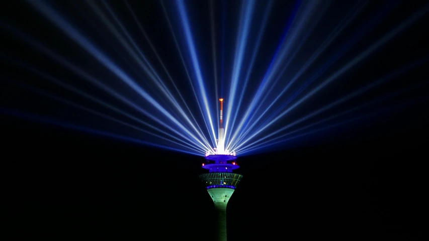 a very tall tower with a lot of lights on it, a hologram, by Thomas Häfner, pexels contest winner, fan favorite, blue and green light, crown of white lasers, 3 6 0 projection
