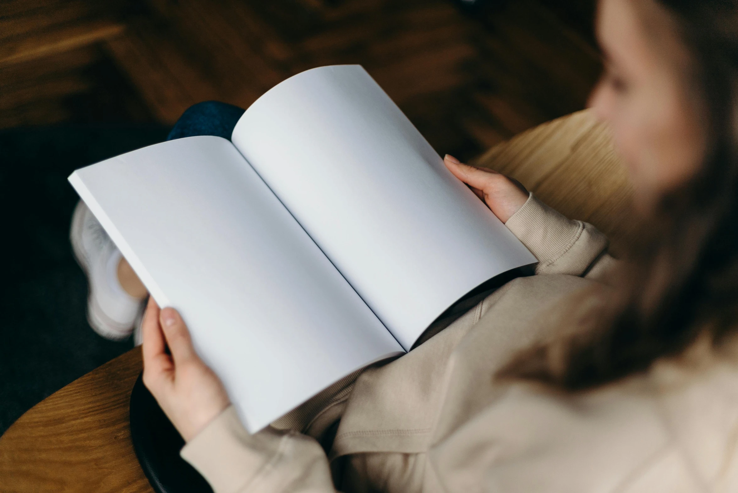 a woman sitting in a chair reading a book, a drawing, pexels contest winner, wearing a white shirt, high angle close up shot, avatar image, big open book