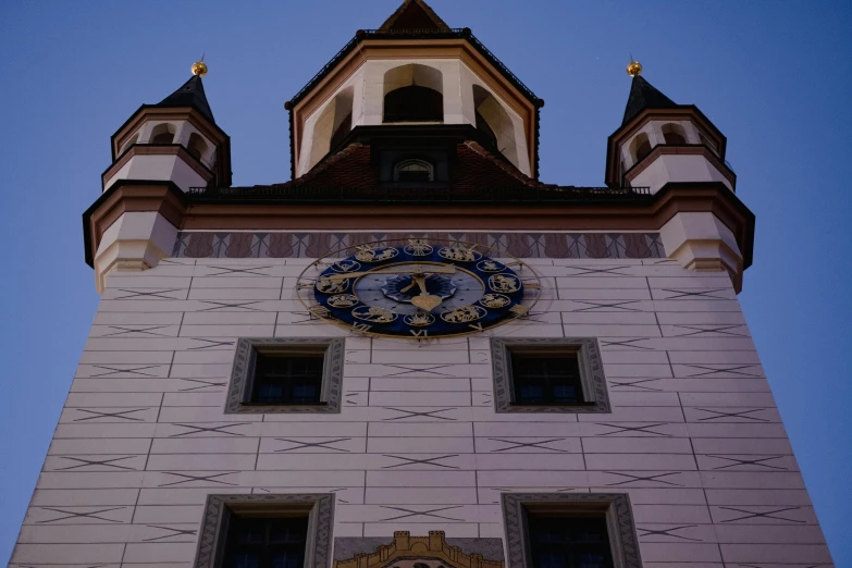 a clock that is on the side of a building, the castle, light and dark, morhbacher, town hall