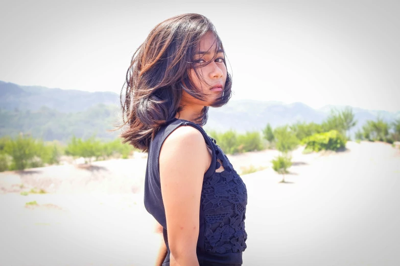 a woman in a black dress posing for a picture, an album cover, pexels contest winner, tachisme, side portrait rugged girl, asian women, profile image, with textured hair and skin