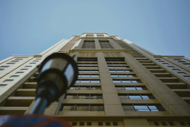 a street light in front of a tall building, inspired by Ricardo Bofill, unsplash, photorealism, low - angle go - pro view, cinematic shot ar 9:16 -n 6 -g, low quality photo, high rise buildings