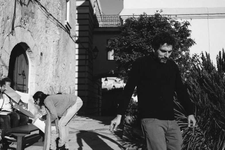 a black and white photo of a man on a skateboard, a black and white photo, by Alexis Grimou, background : diego fazio, the caretaker, monia merlo, sneaking