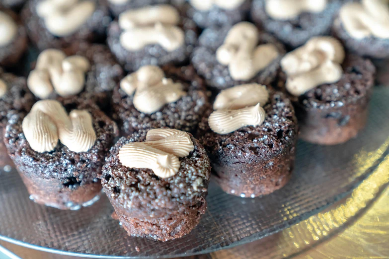 a glass plate topped with cupcakes covered in frosting, by Matt Cavotta, unsplash, hurufiyya, rocky roads, 3 mm, sculpted, brunettes