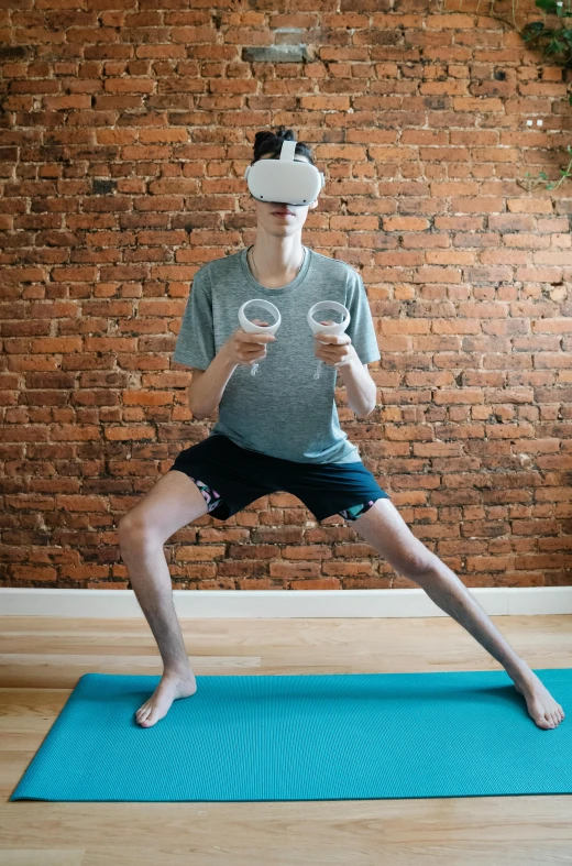 a man standing on a yoga mat in front of a brick wall, a hologram, unsplash, renaissance, vr goggles, fighting posture, wearing goggles, vitalik buterin