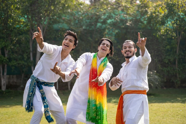 a group of men standing on top of a lush green field, an album cover, shutterstock, bengal school of art, wearing festive clothing, colors white!!, dancing with each other, thumbnail