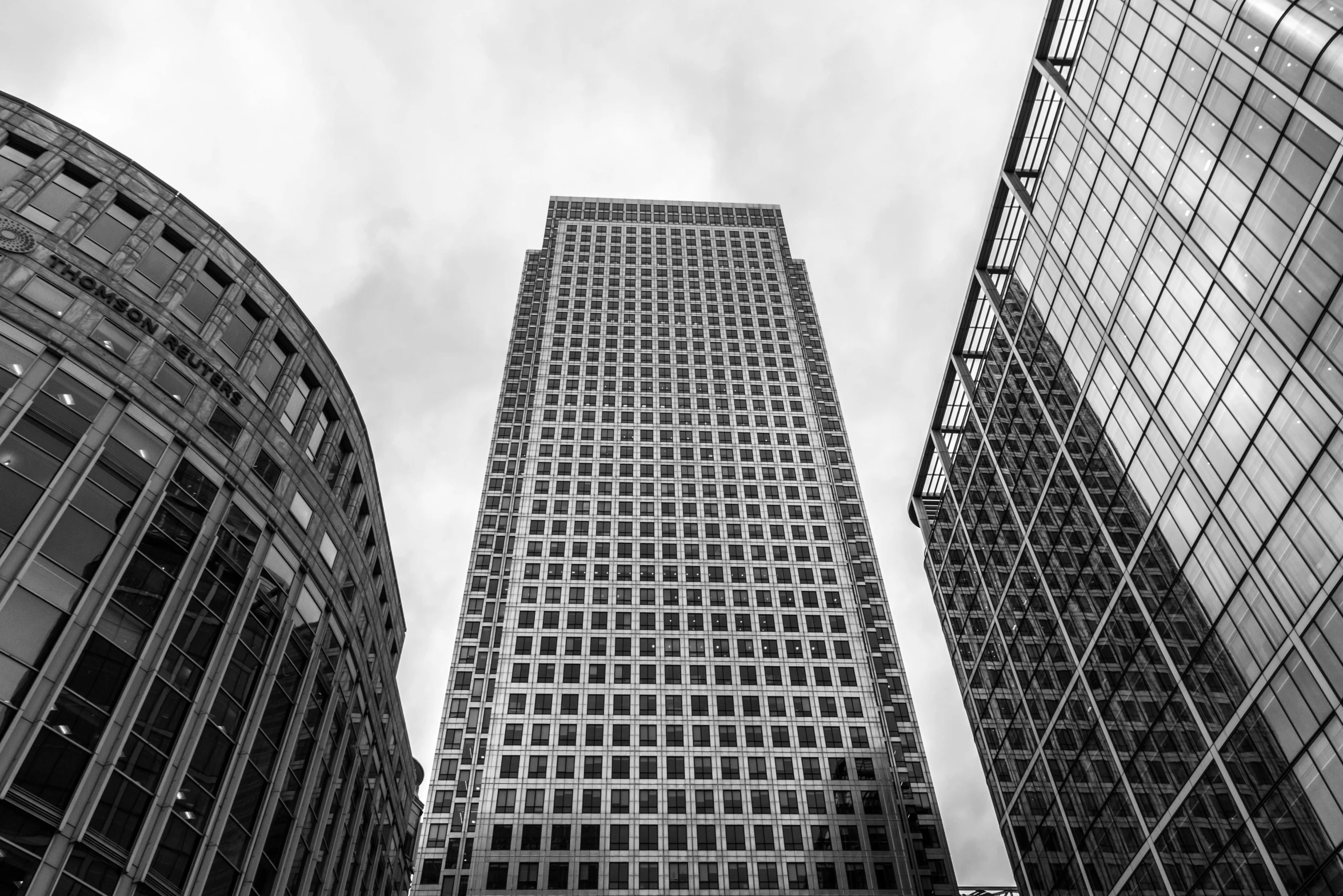 a black and white photo of a tall building, by Adam Rex, pexels contest winner, canary wharf, square, high quality picture, large tall