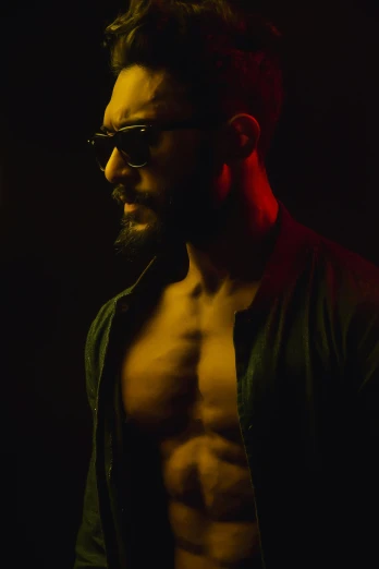 a shirtless man standing in the dark, an album cover, pexels, man with glasses, riyahd cassiem, bearded beautiful man, demon male