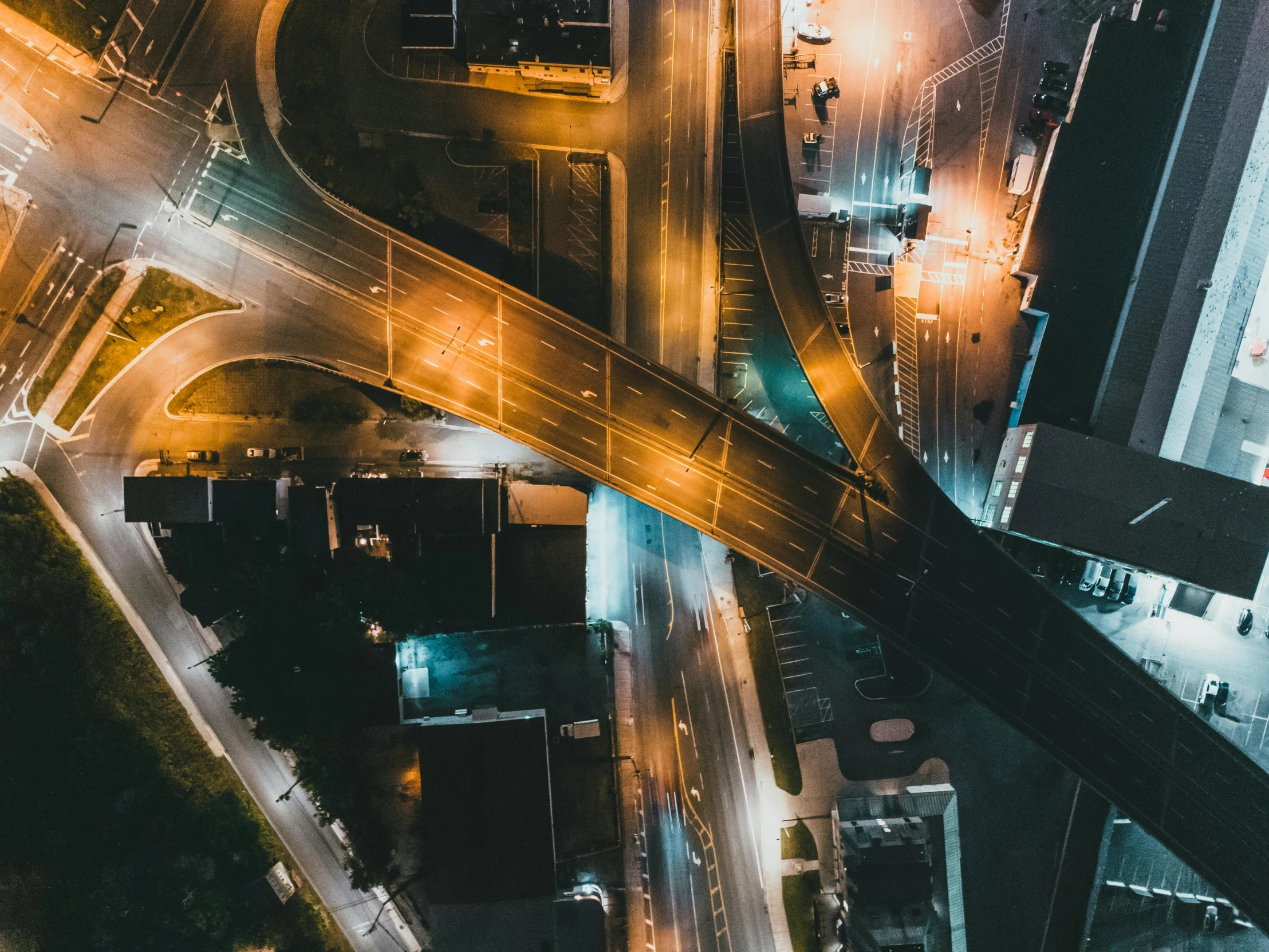 an aerial view of an intersection at night, a screenshot, unsplash contest winner, infrastructure, thumbnail, vibrant and dynamic, instagram post