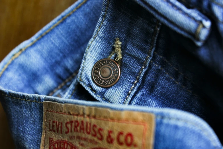 a close up of a pocket of a pair of jeans, unsplash, vintage levi ’ s ad, photorealistic image, the dress\'s lower, items