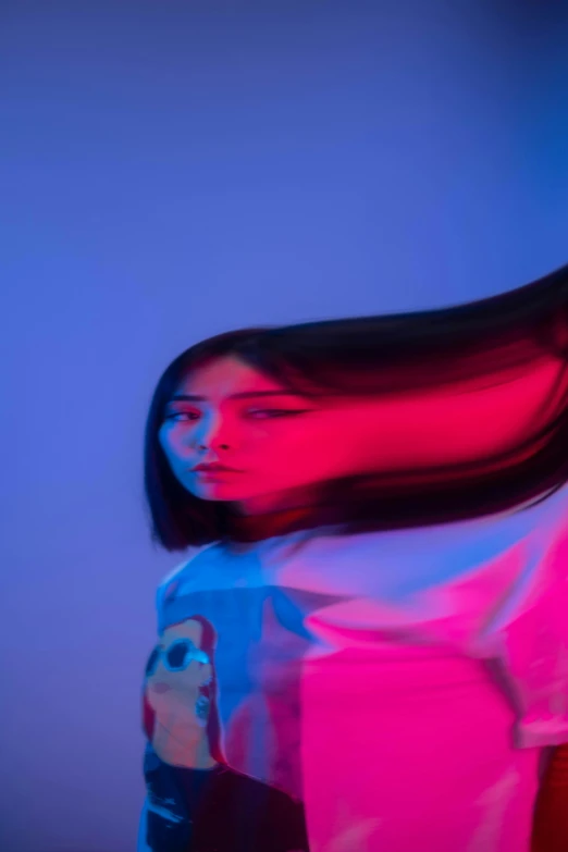 a woman with long hair standing in front of a blue background, an album cover, inspired by Yanjun Cheng, pexels contest winner, red and blue back light, shigeto koyama, flying hair, close - up photograph