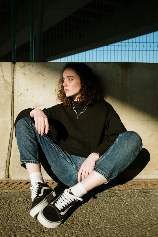 a woman sitting on the ground with a skateboard, inspired by Elsa Bleda, trending on pexels, renaissance, black turtle neck shirt, curly haired, portrait androgynous girl, profile pic