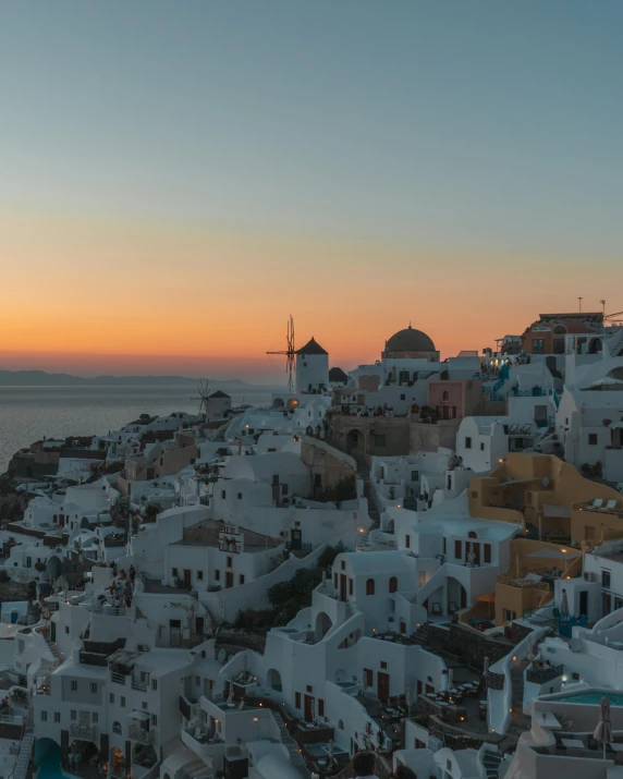 the sun sets over the village of oia on the greek island of santo, pexels contest winner, renaissance, lgbtq, background image, 2 0 0 0's photo, full body photo