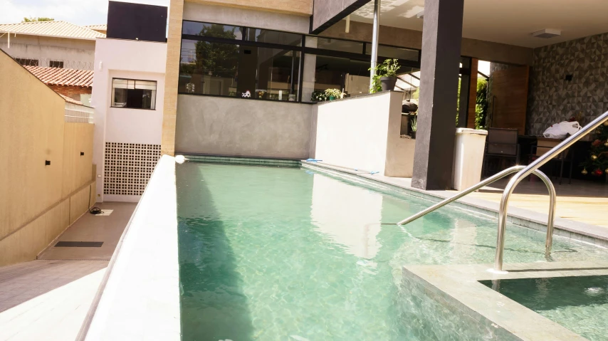 a close up of a swimming pool near a building, by Hirosada II, natural light outside, 2 colours, manly, health spa and meditation center