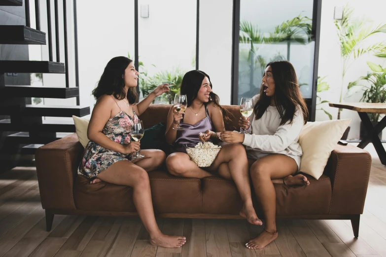 a group of women sitting on top of a couch, pexels contest winner, themed after wine, wearing a camisole and shorts, trio, te pae