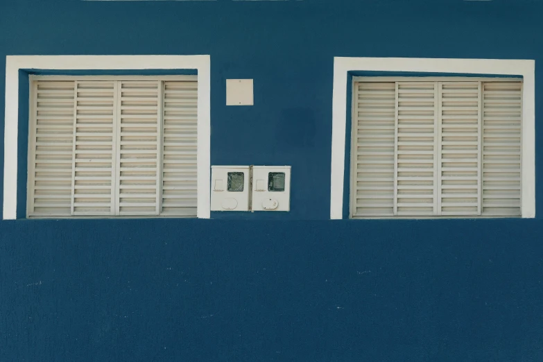 a red fire hydrant sitting in front of a blue building, an album cover, by Elsa Bleda, pexels contest winner, postminimalism, blue shutters on windows, puerto rico, adult pair of twins, plain walls |somber white eyes