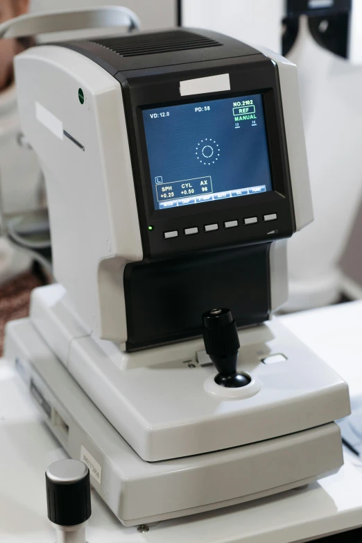 a close up of a machine on a table, eyesight, button potenciometers, front facing, displays