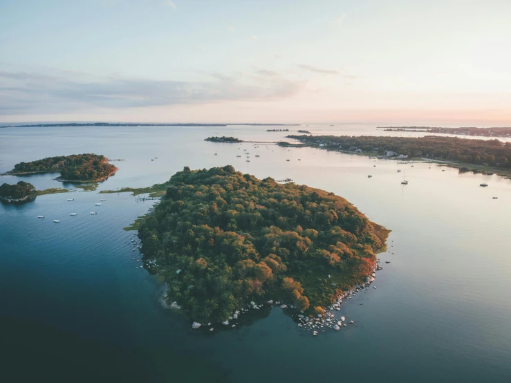 an island in the middle of a body of water, by Jesper Knudsen, pexels contest winner, hurufiyya, rhode island, summer setting, scattered islands, soft glow