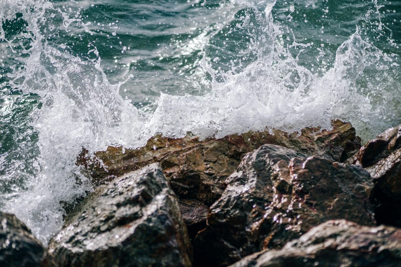 a person riding a surfboard on top of a wave, pexels contest winner, figuration libre, waves crashing at rocks, water texture, thumbnail, sparkling cove