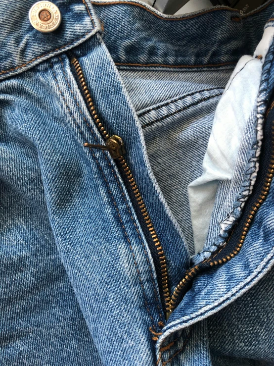 a close up of a pair of jeans, a macro photograph, by Ben Zoeller, hyperrealism, 90’s vibe, highly detailed # no filter, 1990's sears portrait photo, golden details