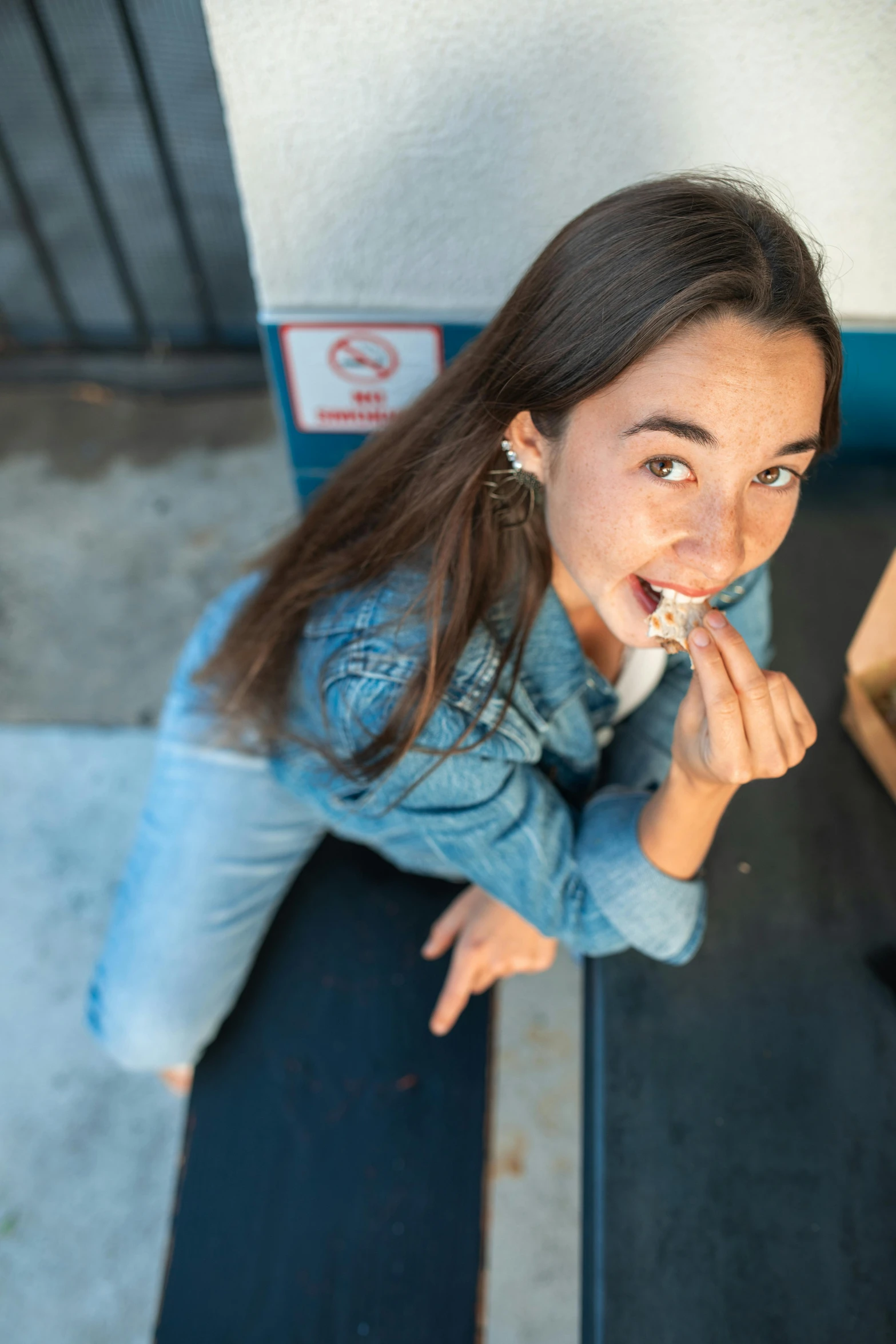 an overhead view of a woman brushing her teeth, pexels contest winner, happening, wearing a jeans jackets, isabela moner, having a snack, tongue out