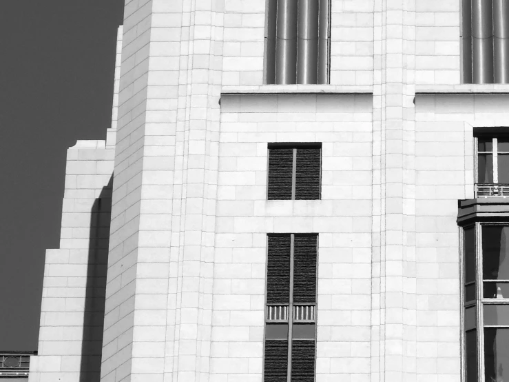 a black and white photo of a tall building, a black and white photo, inspired by Hugh Ferriss, brutalism, official courthouse, white in color, albuquerque, hoog detail