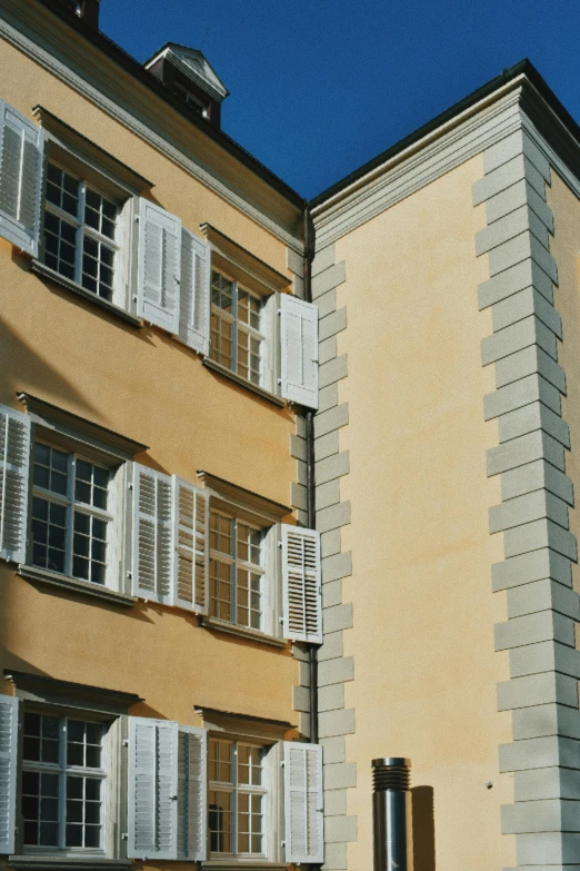 a couple of buildings that are next to each other, inspired by Wilhelm Marstrand, neoclassicism, shutters, ocher, wall corner, high-angle