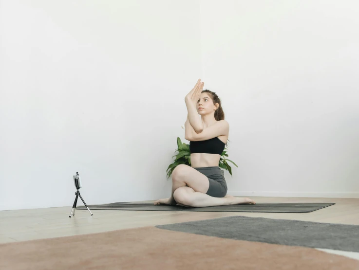 a woman sitting on the floor doing a yoga pose, a statue, unsplash, arabesque, background image, sitting in an empty white room, animation, face and upper - body focus