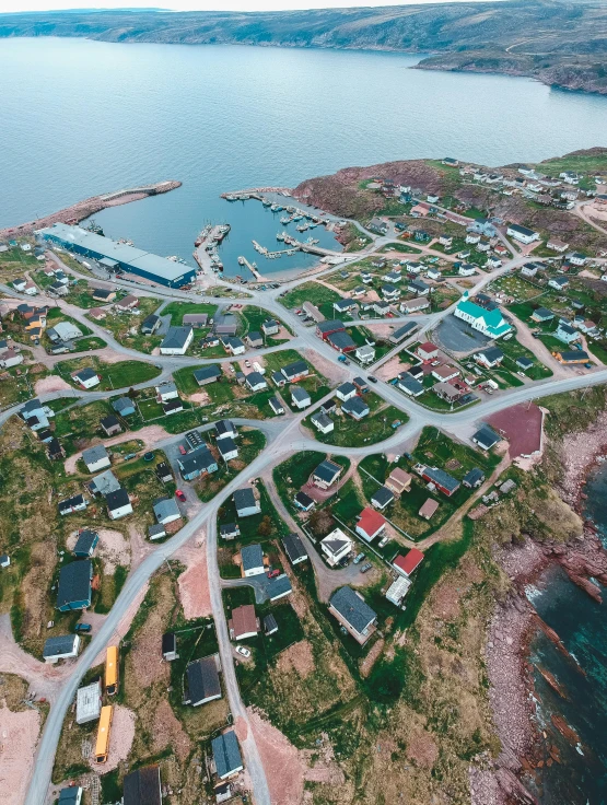 an aerial view of a small town next to a body of water, inuit heritage, drone photo, fan favorite, 8k octan photo