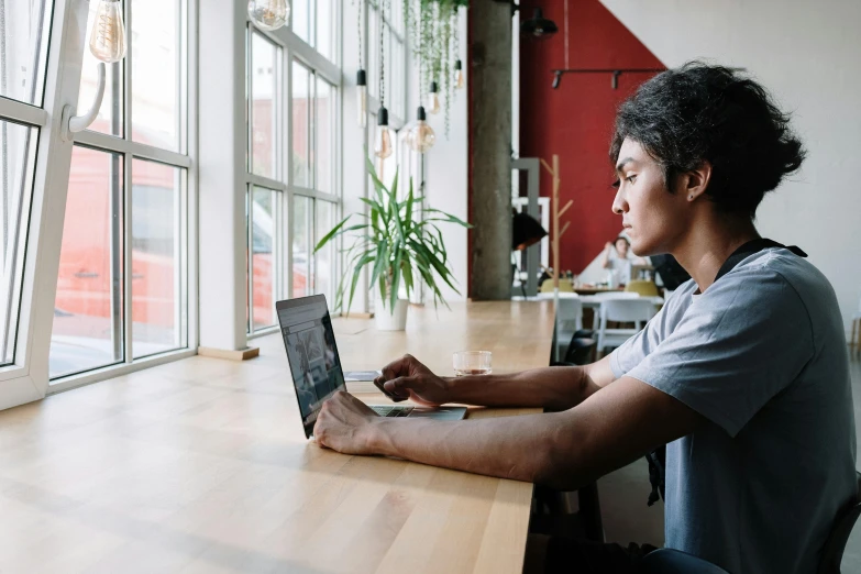 a person sitting at a table with a laptop, a portrait, trending on unsplash, big windows, asian male, lachlan bailey, avatar image