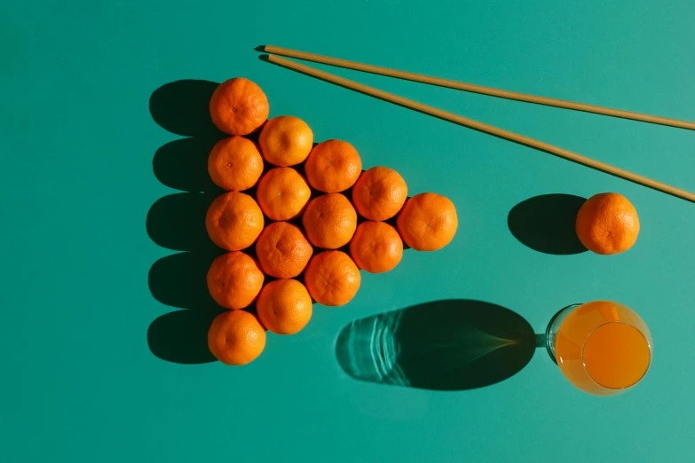 a bunch of oranges sitting next to a glass of orange juice, inspired by Mike Winkelmann, unsplash contest winner, floating spheres and shapes, chopsticks, teal and orange colour palette, group photo