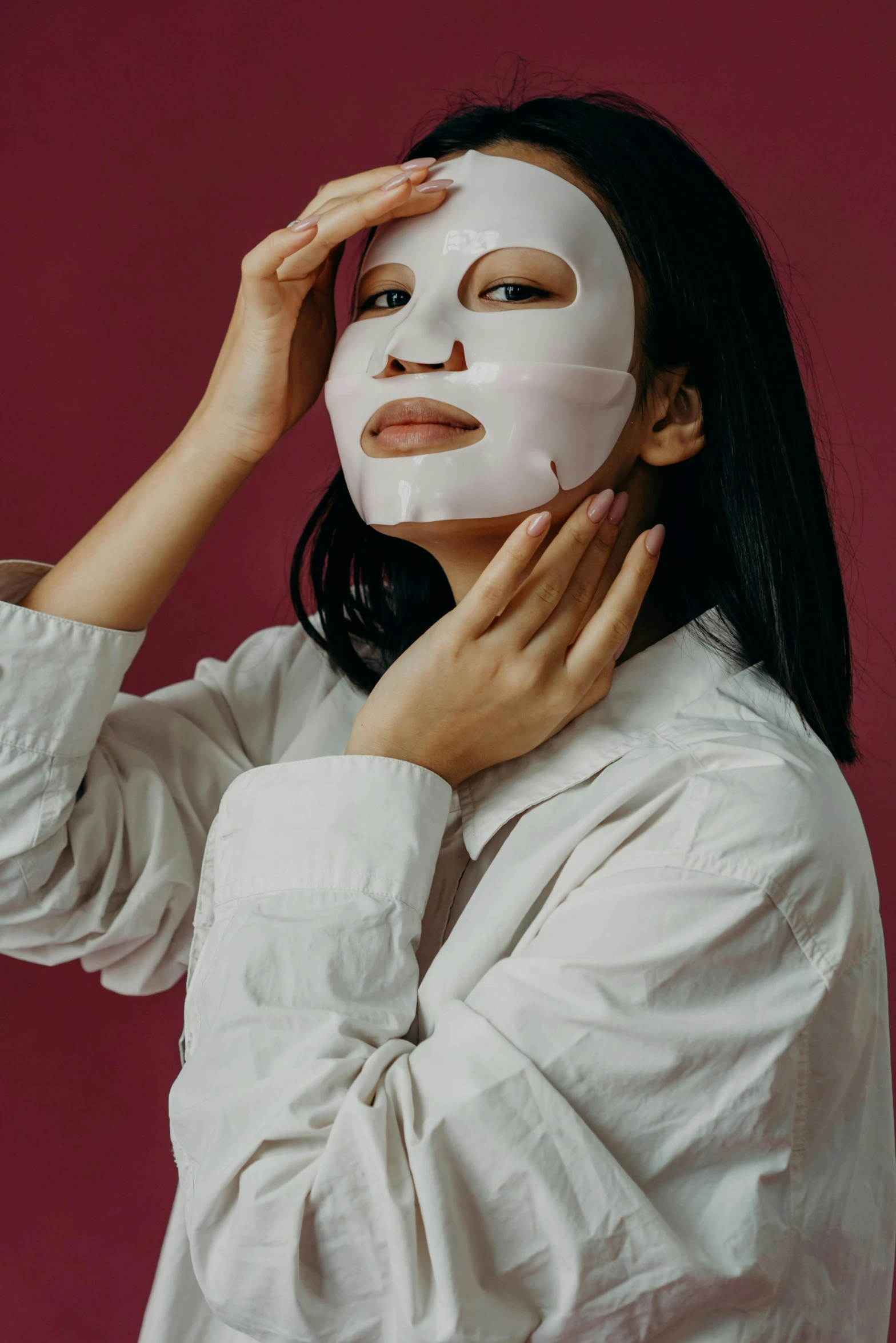 a woman putting a mask on her face, trending on pexels, portrait of mulan, full face and body portrait, glomy, cover story