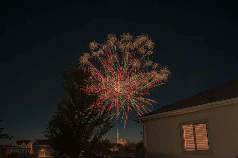 a firework is lit up in the night sky, a picture, by Ejnar Nielsen, unsplash contest winner, renaissance, in a suburban backyard, fourth of july, profile image, iso 1 0 0 wide view