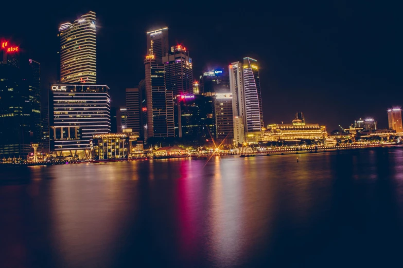 the city skyline is lit up at night, by Patrick Ching, pexels contest winner, hyperrealism, building along a river, header, high quality image, slight haze