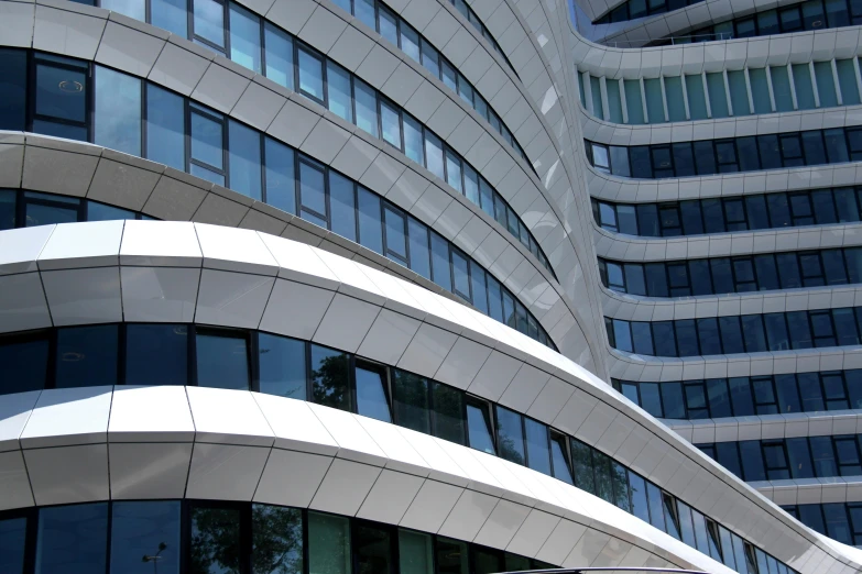 a close up of a building with many windows, inspired by Zaha Hadid, flickr, sustainable architecture, ground - level view, spiral lines, subtle detailing