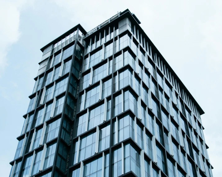 a very tall building with lots of windows, inspired by Tadao Ando, unsplash, iron cladding, opaque glass, side - view, square