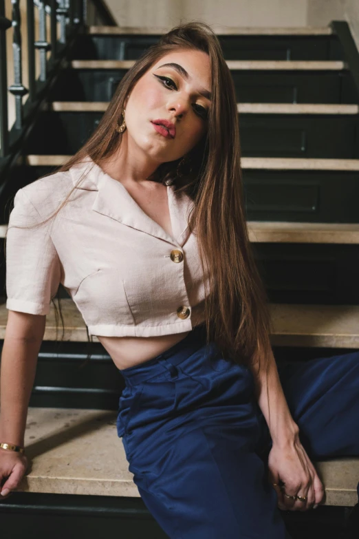 a woman sitting on a set of stairs, by Nina Hamnett, trending on pexels, renaissance, wearing a cropped top, collared shirt, delicate pale pink lips, navy