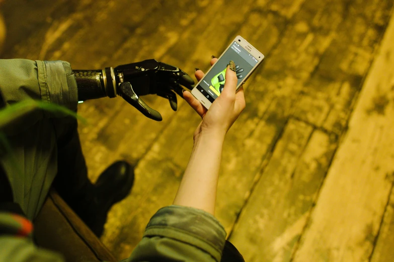 a close up of a person holding a cell phone, interactive art, massive steampunk hands, robotic limbs on floor, superhero, immersive