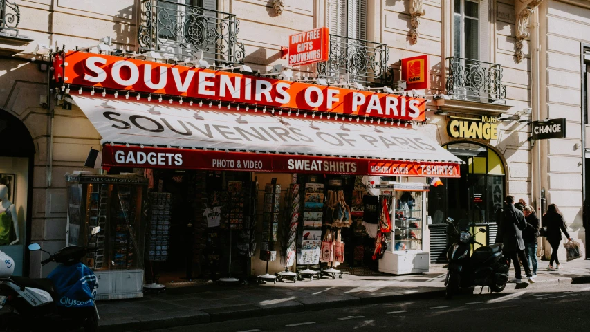 a group of people walking down a street in front of a store, pexels contest winner, art nouveau, awnings, the city of paris, bright signage, 🚿🗝📝