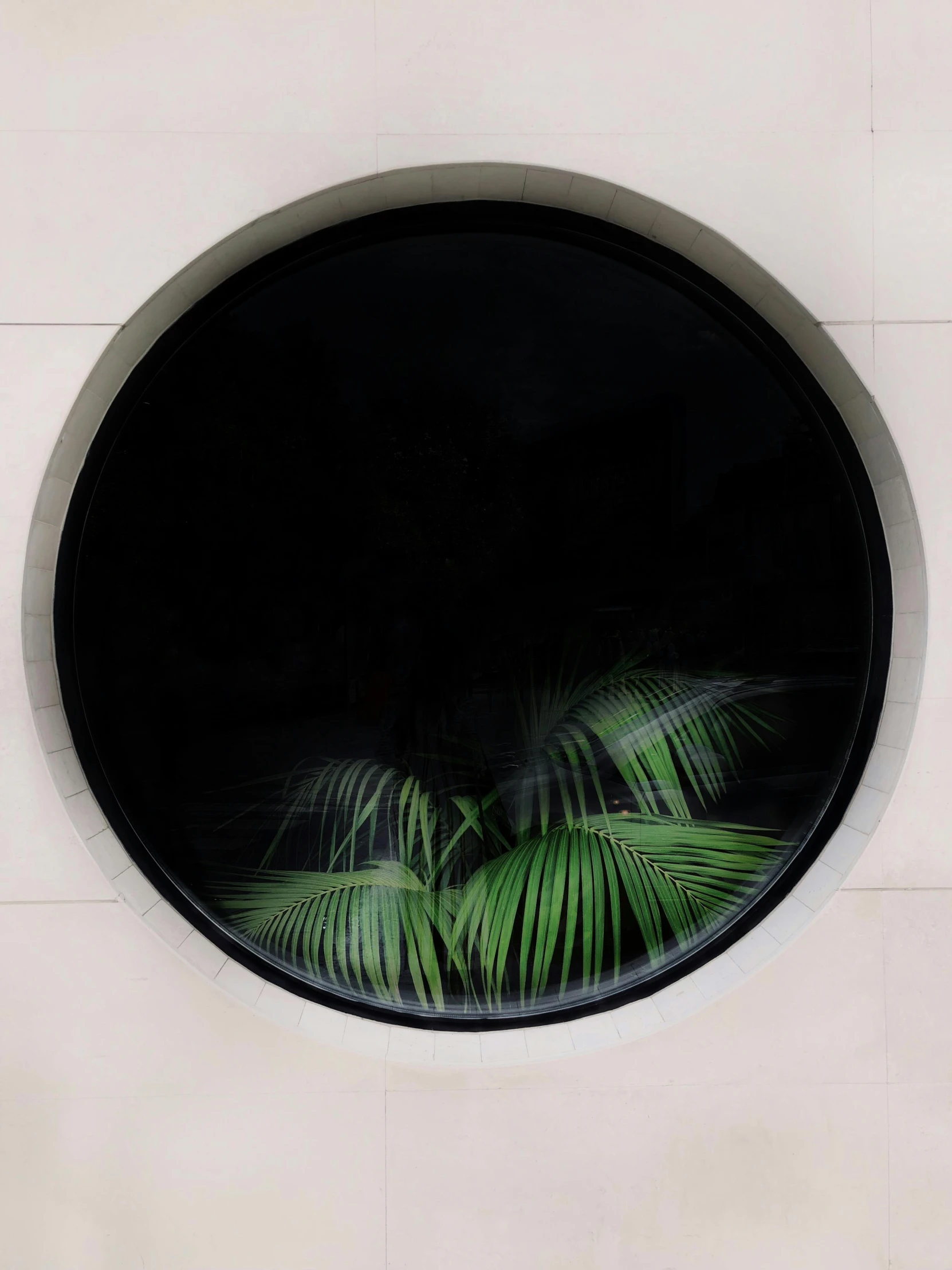 a round window on the side of a building, an album cover, trending on unsplash, modernism, lush jungle, panel of black, fronds, anish kapoor black