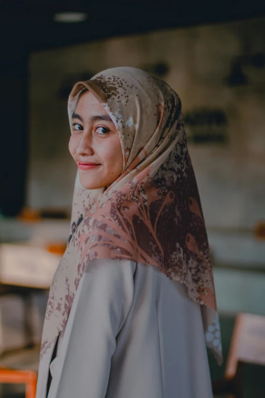 a close up of a person wearing a headscarf, standing in class, dreamy, background image, smiling sweetly