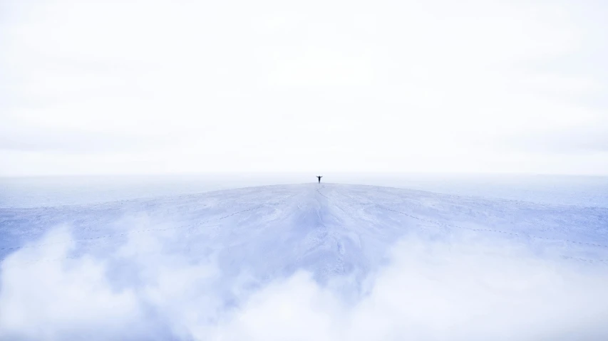 a person standing on top of a snow covered hill, inspired by jessica rossier, pexels contest winner, minimalism, cloud vortex, white floor, full view blank background, abstract photography