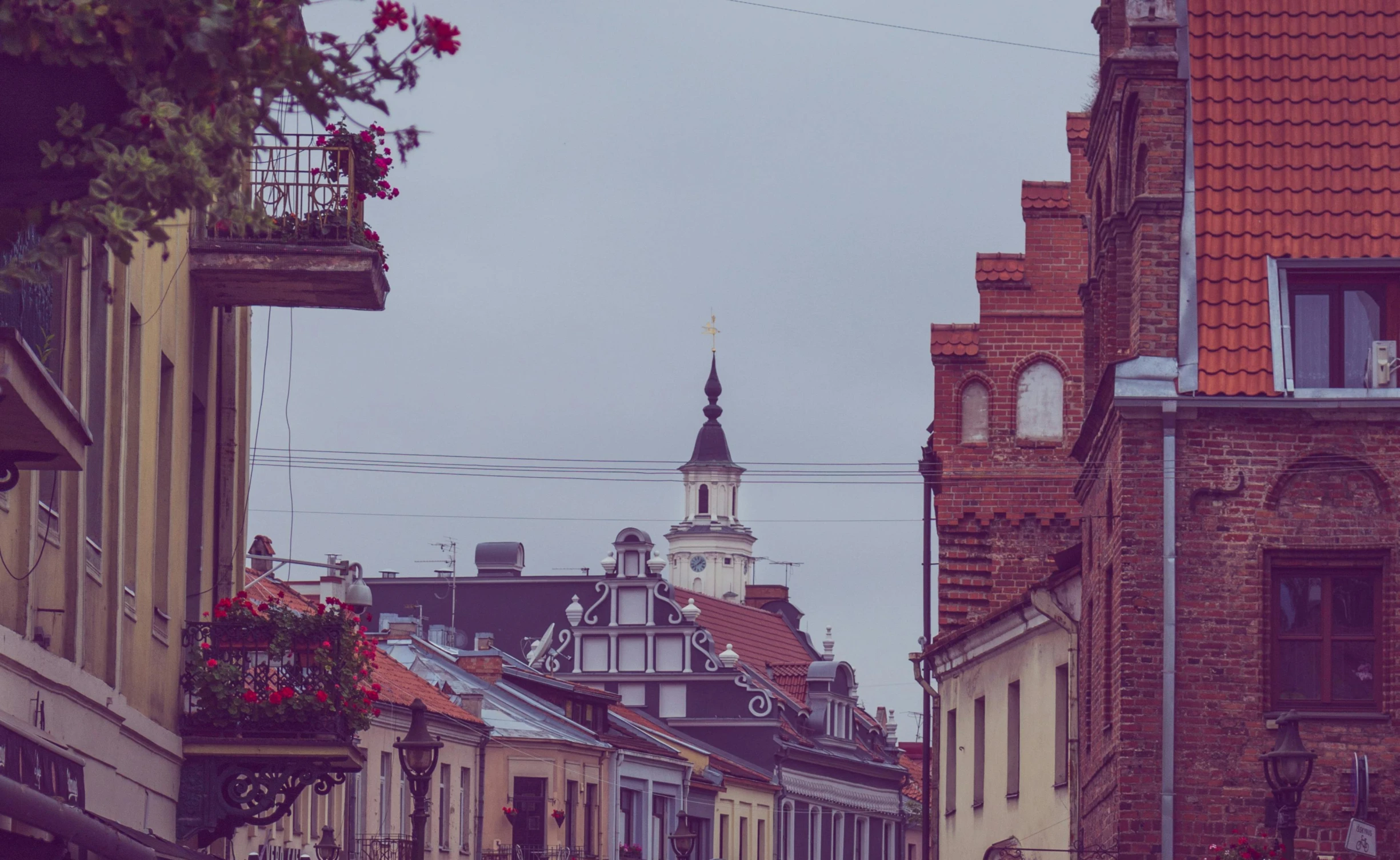 a group of people walking down a street next to tall buildings, by Adam Marczyński, pexels contest winner, baroque, ground level view of soviet town, flowers, background image, roofs