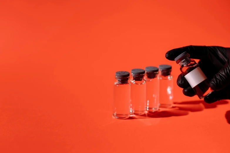 a person in black gloves holding a bottle of liquid, trending on pexels, visual art, blood collection vials, white and red color scheme, a clockwork orange, minimalistic background