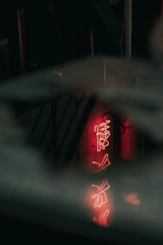 a red neon sign sitting on the side of a building, captured in bottles, with ancient chinese aesthetic, dark mood lighting, ( ( theatrical ) )